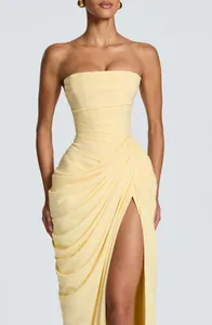 Elegant pale yellow strapless floor-length dress with ruched details and a high side slit