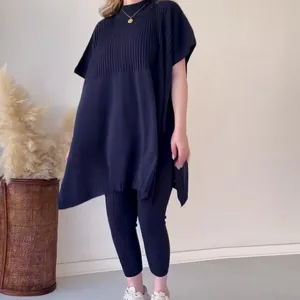 Conjunto negro de punto de dos piezas para mujer con top murciélago y leggings