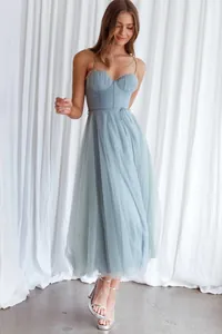 Detailed look at the flowing tulle layers and structured corset bodice of the blue dress