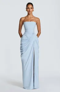 Detail view of light blue strapless maxi dress with elegant draping and high slit