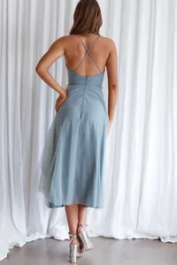 Detailed back view of an elegant light blue tulle evening dress with cross back straps