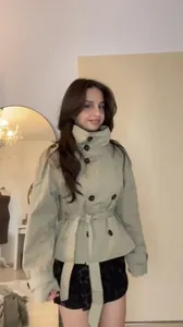 Stylish khaki double-breasted short trench coat featuring high collar and waist belt