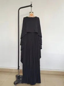 Detailed view of elegant black batwing sleeve top with pleated maxi skirt modest set