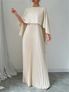 Elegant beige batwing top and pleated maxi skirt set shown in full-body detail