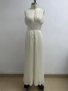 Full-length view of white pleated wide-leg jumpsuit with high neck and front zipper