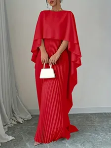Full-length view of a bright red elegant pleated maxi skirt and matching cape top