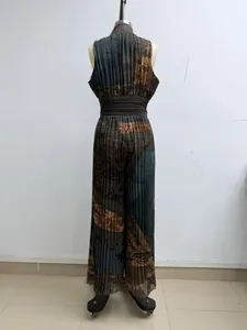 Rear view of a sleeveless pleated wide-leg jumpsuit with a dark abstract earthy print