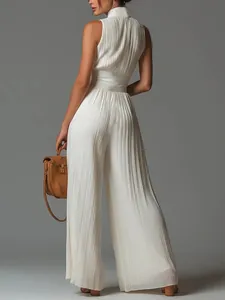 Detailed back view of a white pleated halter jumpsuit featuring an elegant wide-leg silhouette