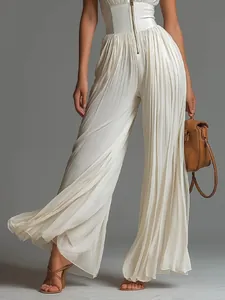 Close-up of elegant white pleated wide-leg jumpsuit with corset-style waist detail.