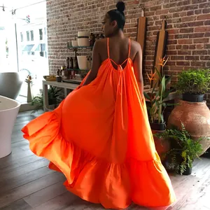 Back view of a vibrant orange sleeveless maxi dress with thin straps and a flowy ruffled hem.