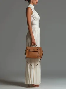 Side profile of an elegant white pleated halter jumpsuit featuring stylish wide-leg trousers