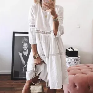 Elegant white boho dress with lace hollow embroidery and 3/4 sleeves, stylish midi length.