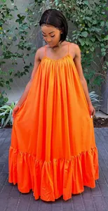 Full view of vibrant orange spaghetti strap maxi dress with ruffled hem and loose fit