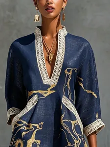 Close-up of the lace trim and gold abstract print on a navy cotton linen vacation dress.
