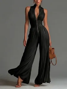 Detail shot of black pleated sleeveless wide-leg jumpsuit with deep V-neck and zipper