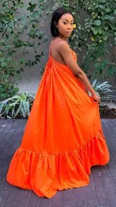 Elegant vibrant orange backless maxi dress with thin halter straps and ruffled hem