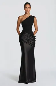 Full view of black one-shoulder satin dress featuring elegant pleating and slim silhouette.