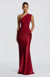 Elegant burgundy one-shoulder ruched satin evening gown detail with slim fit design