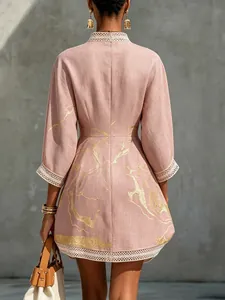 Back view of pink cotton linen mini dress with gold abstract print and delicate lace trim
