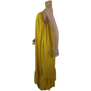Side view detail showing the ruffled hem and loose fit of the yellow sleeveless maxi dress