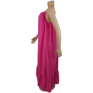 Side view of a vibrant pink sleeveless loose maxi dress with tiered ruffle hem detail