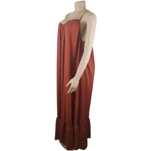 Detailed side view of a terracotta loose maxi suspender dress featuring a ruffled hem