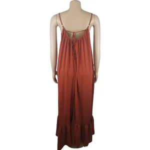 Back view of a loose terracotta maxi dress with delicate spaghetti straps and tie details.