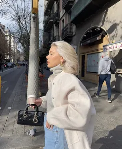 Elegant cream stand-collar cardigan jacket for women styled in a chic urban street setting