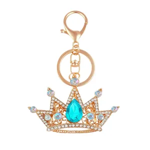 Elegant gold-tone crystal crown keychain with vibrant turquoise teardrop gemstone accessory