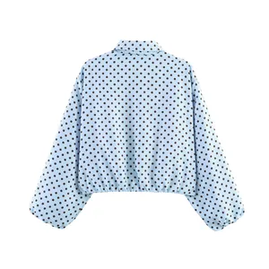 Vista trasera de una chaqueta azul claro con lunares, mangas abullonadas y corta