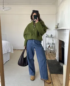 Elegant olive green stand-up collar jacket styled with wide-leg denim jeans in mirror selfie