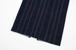 Close-up of contrast stitching and rear vent detail on a dark blue denim midi dress