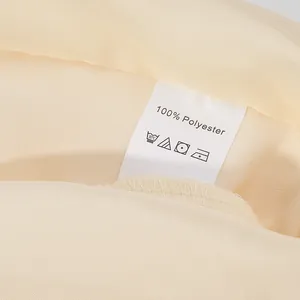 Detailed close-up showing the 100% polyester material care label on a satin garment