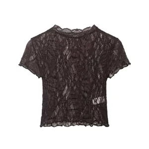 Close-up detail of dark brown vintage floral lace fabric on short sleeve top