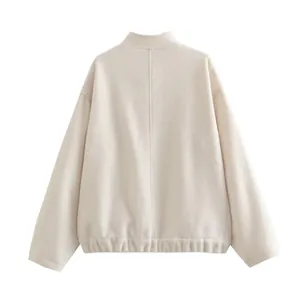 Detailed back view of a minimalist cream stand collar jacket with elasticated hem