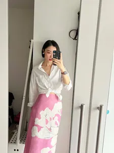 Full view of a pink linen-blend midi skirt with white floral print pattern