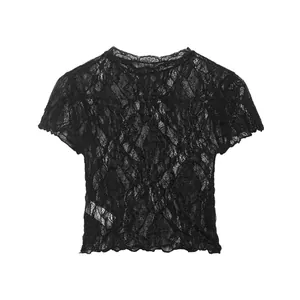 Macro detail of a black short-sleeved lace T-shirt showing intricate floral patterns