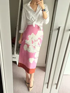Stylish pink linen-blend printed midi skirt with elegant floral motifs and red hem