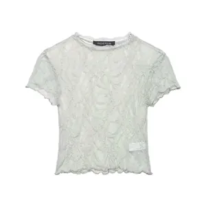 Detailed view of the elegant texture on a light green retro flocked lace short-sleeve T-shirt