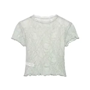 Close-up of vintage flocked lace texture on short-sleeved T-shirt with lettuce trim