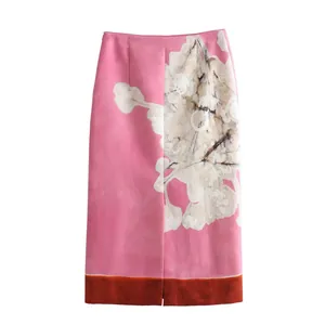 Elegant pink linen blend midi skirt featuring floral print and orange contrast hem.