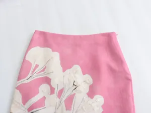 Detailed view of a pink linen blend skirt featuring a white floral print design.