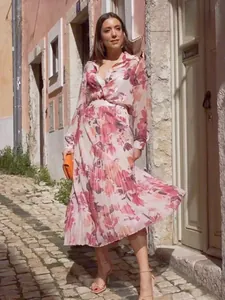 Full body shot of elegant women's floral print blouse and pleated skirt set outdoor