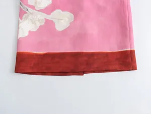 Close-up detail of pink linen blend floral print skirt hem with brown border