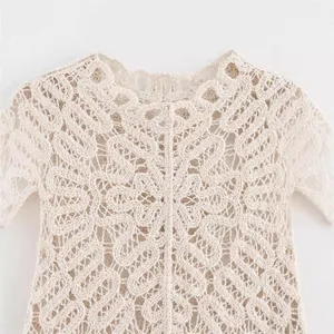 Elegant beige crochet knitted short sleeve top with intricate hollow lace pattern detail