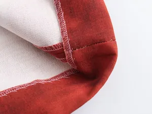 Macro detail of professional stitching and linen blend fabric texture on a printed skirt