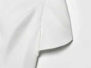 Macro close-up detail of the white structured fabric on a short-sleeved blazer jacket