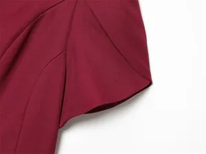 Detailed close-up showing the sleeve cut and premium fabric texture of a burgundy garment