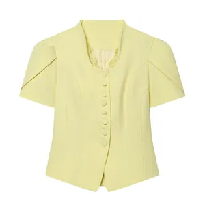 Close-up of yellow short-sleeve blazer featuring delicate lace trim and puff sleeves