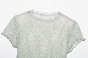 Close-up of light green vintage lace short sleeve T-shirt with delicate flocked texture